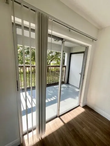 a view of a glass door and wooden floor