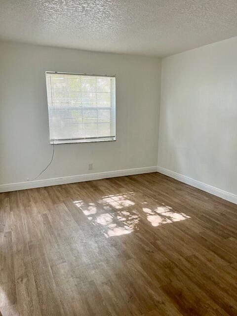 3440 Rudolph Road, Unit 4 Lake Worth, FL 33461 - Photo 6 of 9 wooden floor and window in an empty room