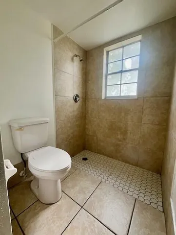 a bathroom with a toilet sink and shower