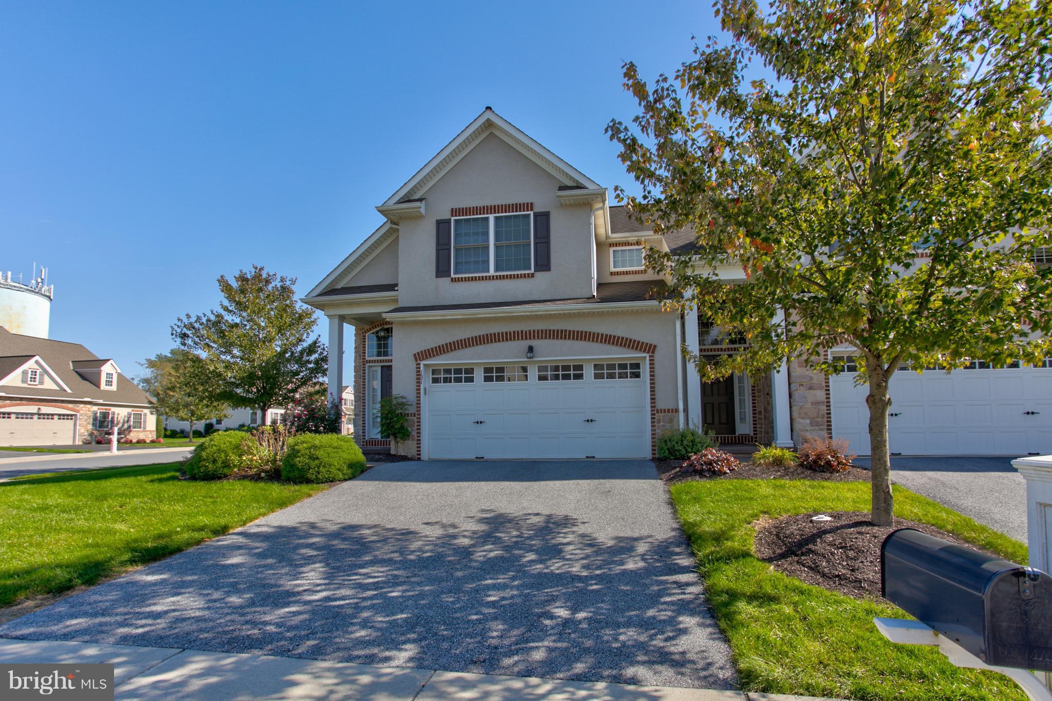 131 Baneberry Lane Lititz, PA 17543 - Photo 2 of 26 a front view of a house with a yard and garage