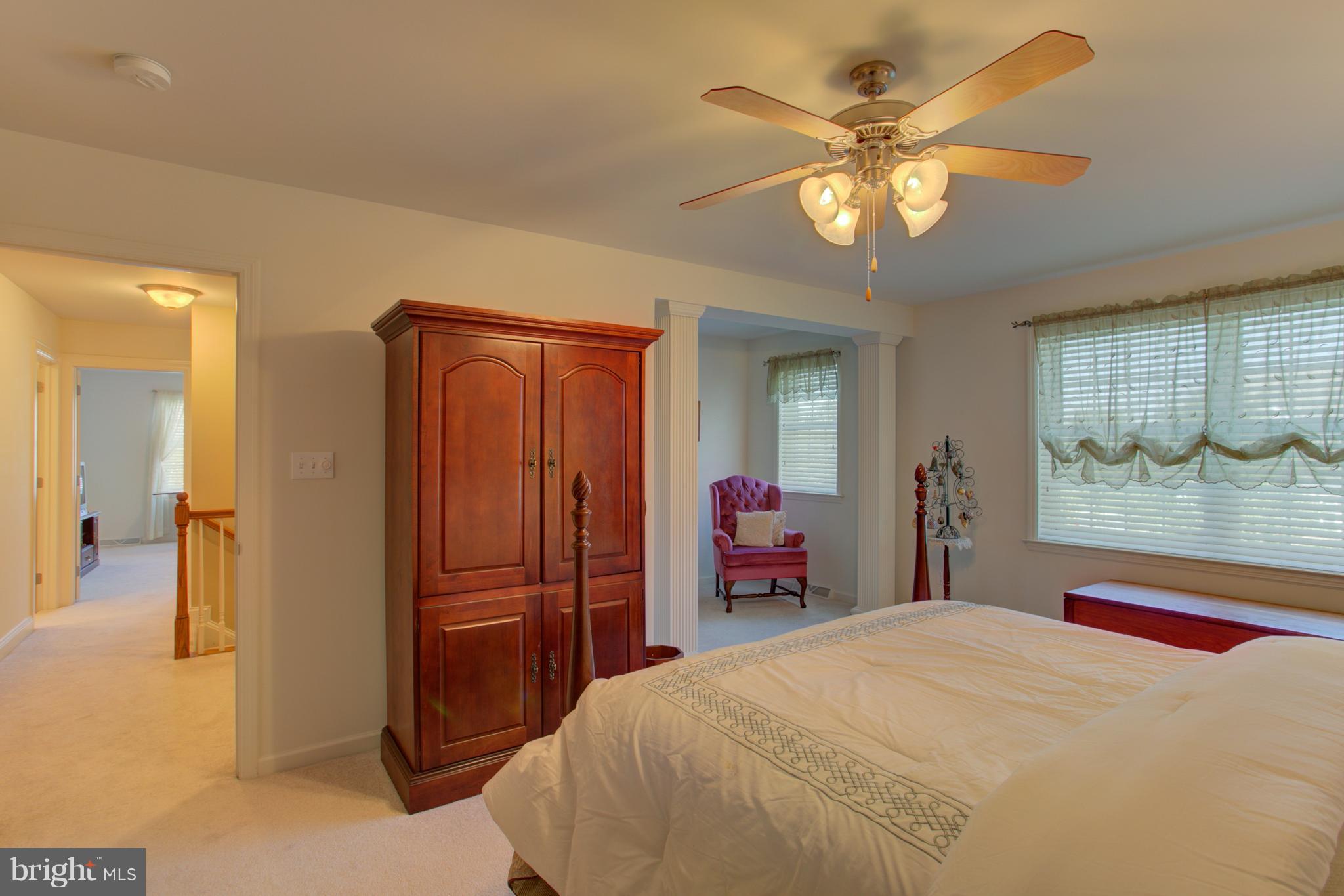 131 Baneberry Lane Lititz, PA 17543 - Photo 20 of 26 a bedroom with a bed and a chandelier