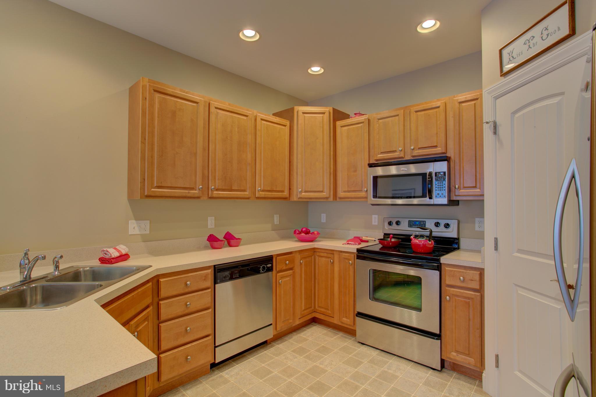 131 Baneberry Lane Lititz, PA 17543 - Photo 6 of 26 a kitchen with stainless steel appliances granite countertop a sink dishwasher stove refrigerator and cabinets with wooden floor