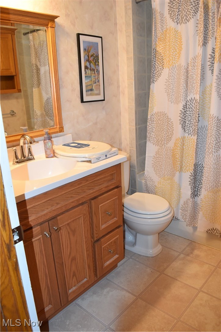 608 Gibbs Road Akron, OH 44312 - Photo 14 of 40 Bathroom with tile patterned floors, vanity, and toilet