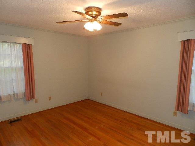 7209 Battle Bridge Road Raleigh, NC 27610 - Photo 11 of 21 an empty room with a window and a fan