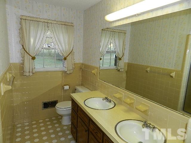 7209 Battle Bridge Road Raleigh, NC 27610 - Photo 12 of 21 a bathroom with a granite countertop toilet sink and mirror