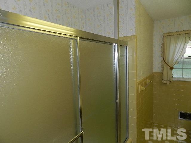 7209 Battle Bridge Road Raleigh, NC 27610 - Photo 13 of 21 a bathroom with a glass shower door