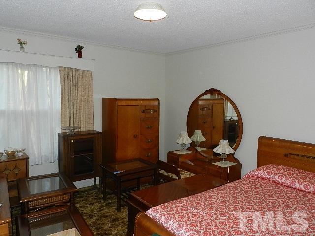 7209 Battle Bridge Road Raleigh, NC 27610 - Photo 15 of 21 a room with furniture mirror and a wooden floor