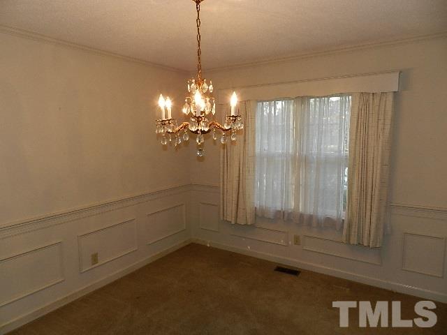 7209 Battle Bridge Road Raleigh, NC 27610 - Photo 4 of 21 a view of a livingroom with a chandelier fan and windows