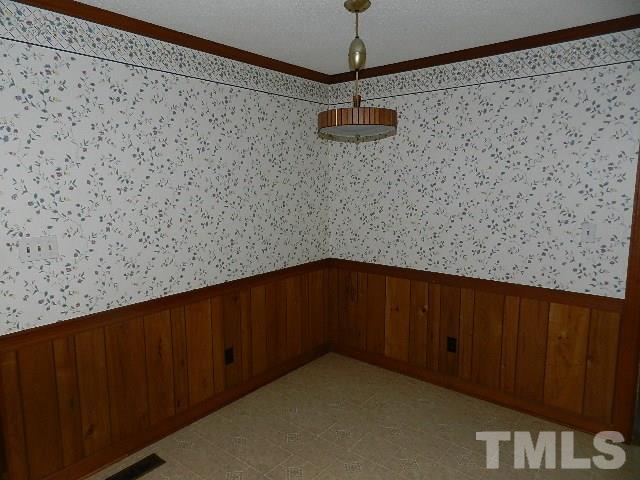 7209 Battle Bridge Road Raleigh, NC 27610 - Photo 7 of 21 a view of a hallway with a wooden door