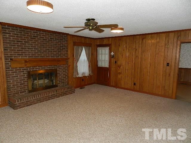 7209 Battle Bridge Road Raleigh, NC 27610 - Photo 9 of 21 a view of an empty room with a fireplace and a window