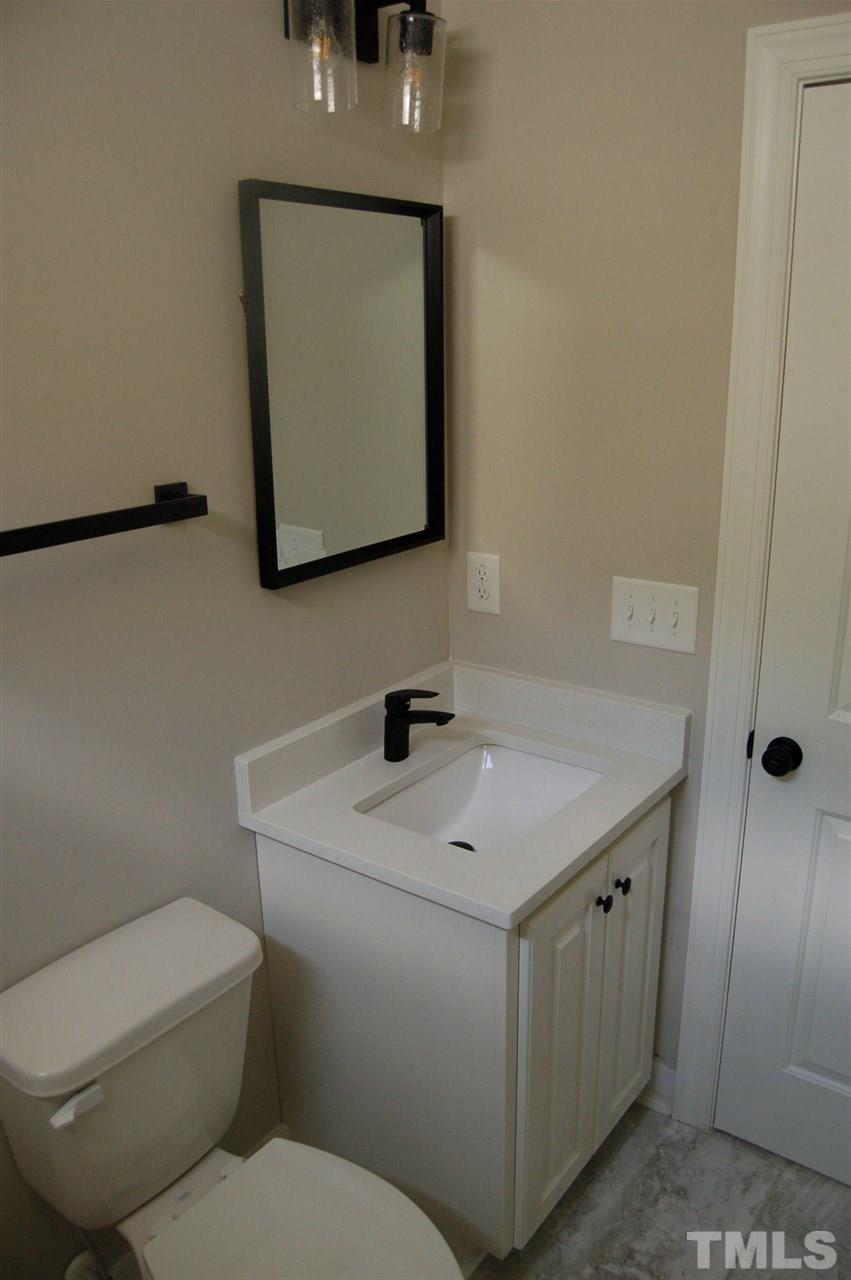 1433 Garner Road Raleigh, NC 27610 - Photo 11 of 23 a bathroom with a toilet sink and mirror