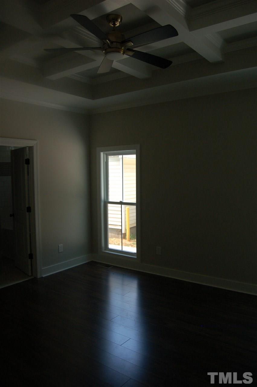 1433 Garner Road Raleigh, NC 27610 - Photo 16 of 23 a view of an empty room with wooden floor and a window