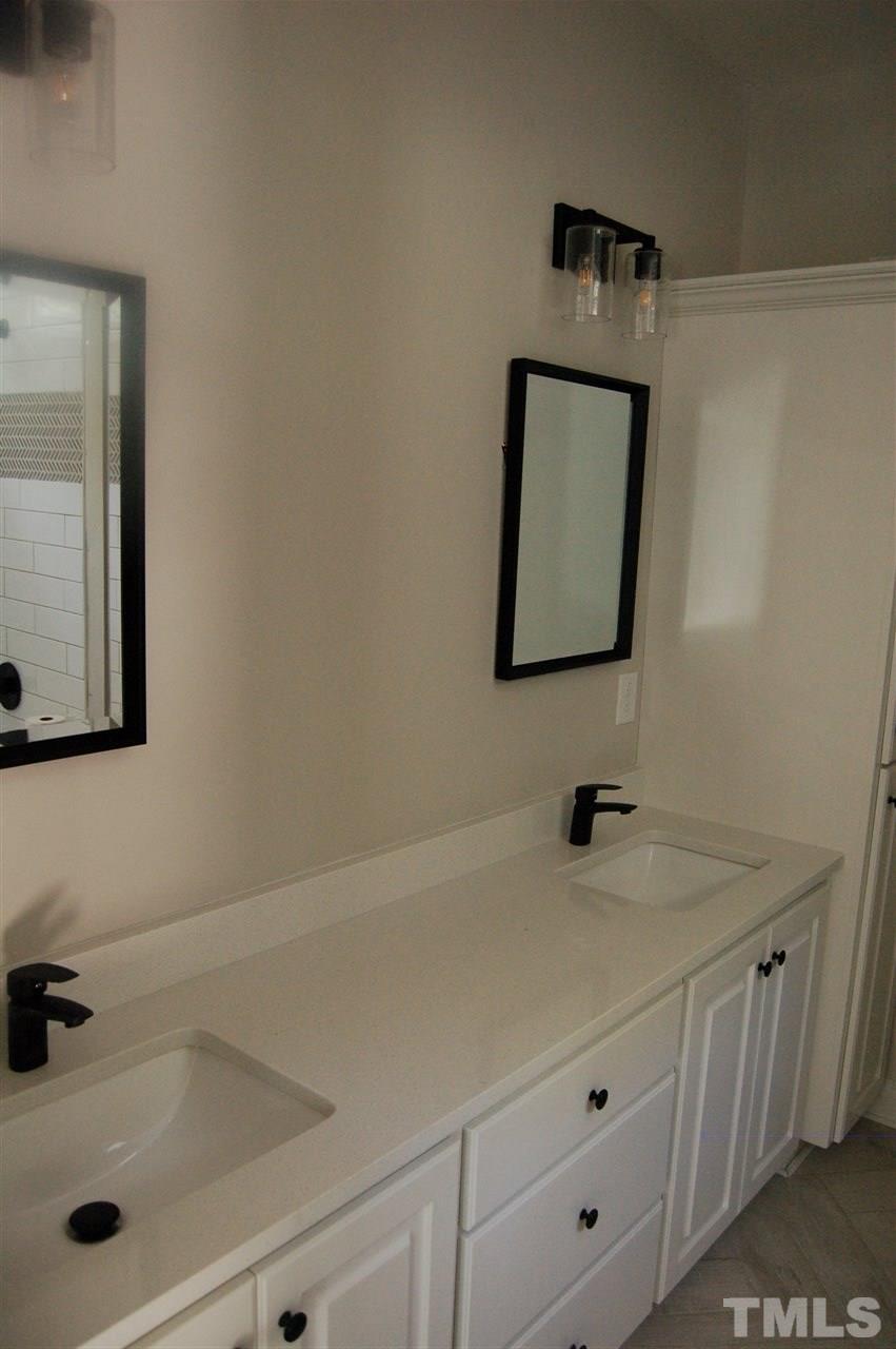 1433 Garner Road Raleigh, NC 27610 - Photo 19 of 23 a bathroom with a sink and a mirror