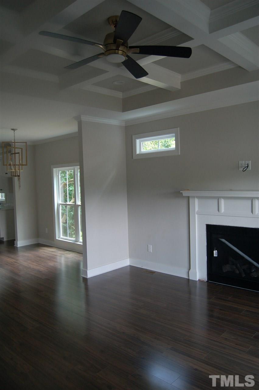1433 Garner Road Raleigh, NC 27610 - Photo 6 of 23 a view of an empty room with wooden floor and a fireplace