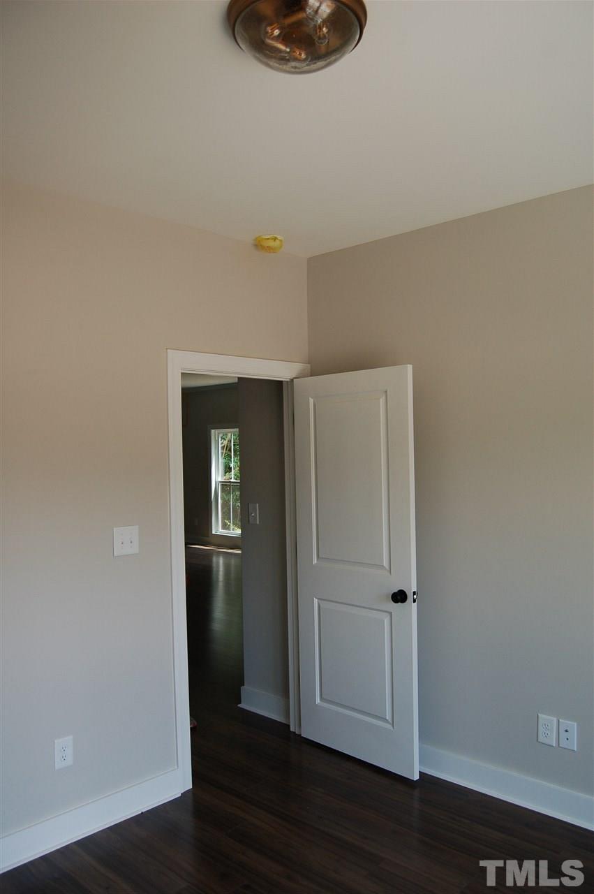 1433 Garner Road Raleigh, NC 27610 - Photo 8 of 23 a view of an empty room with wooden floor and a window
