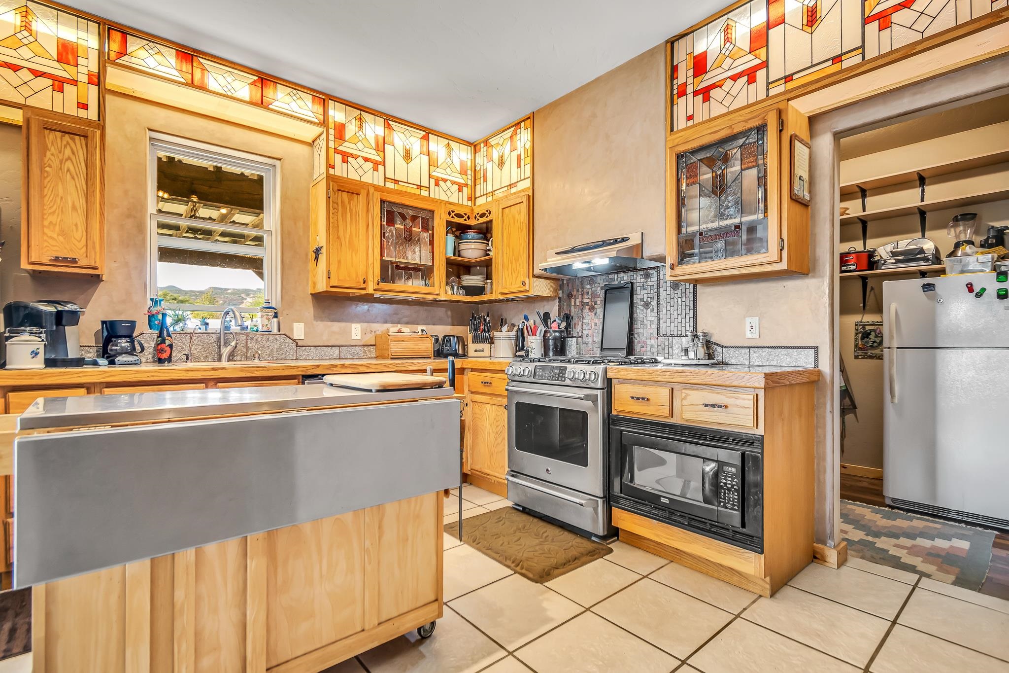962-17 17 1/4 Road Fruita, CO 81521 - Photo 14 of 37 a kitchen with stainless steel appliances granite countertop a stove a sink and a refrigerator