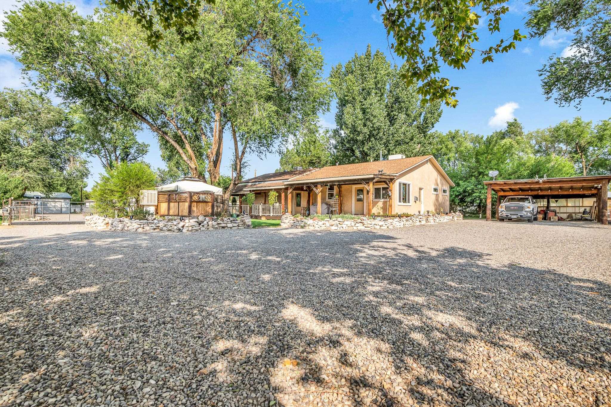 962-17 17 1/4 Road Fruita, CO 81521 - Photo 32 of 37 a view of house with outdoor space and tree s