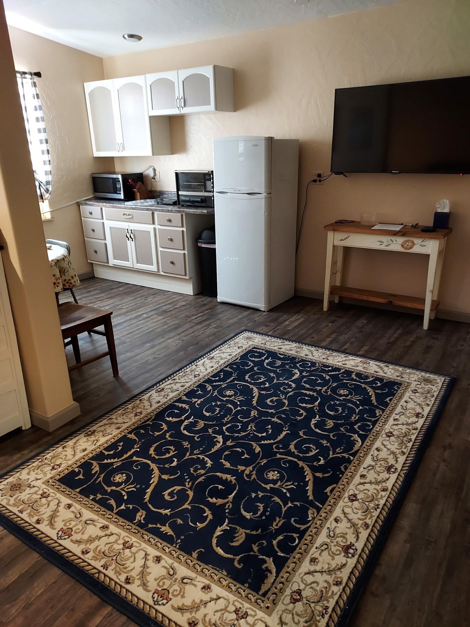 962-17 17 1/4 Road Fruita, CO 81521 - Photo 33 of 37 a kitchen with wooden cabinets and a stove top oven