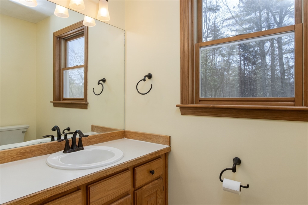 10 Ryan Road Townsend, MA 01474 - Photo 11 of 34 a bathroom with a granite countertop sink and a mirror