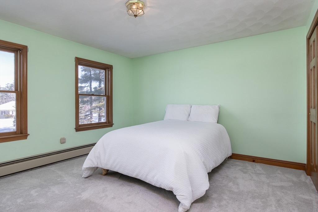 10 Ryan Road Townsend, MA 01474 - Photo 15 of 34 a bed sitting in a bedroom next to a window