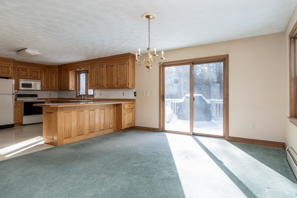 10 Ryan Road Townsend, MA 01474 - Photo 5 of 34 a kitchen with stainless steel appliances granite countertop a stove top oven a sink and a refrigerator