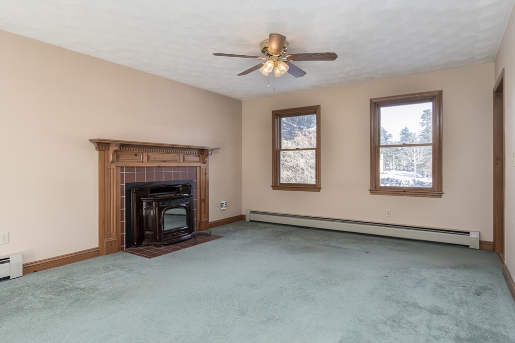 10 Ryan Road Townsend, MA 01474 - Photo 6 of 34 an empty room with windows and fireplace
