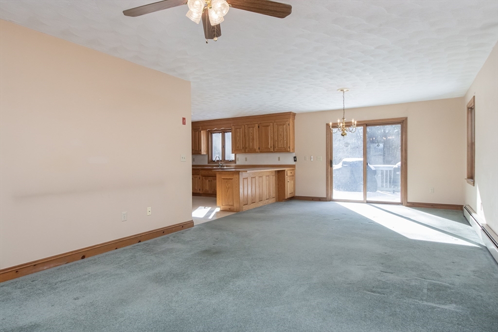 10 Ryan Road Townsend, MA 01474 - Photo 7 of 34 an empty room with chandelier fan and windows