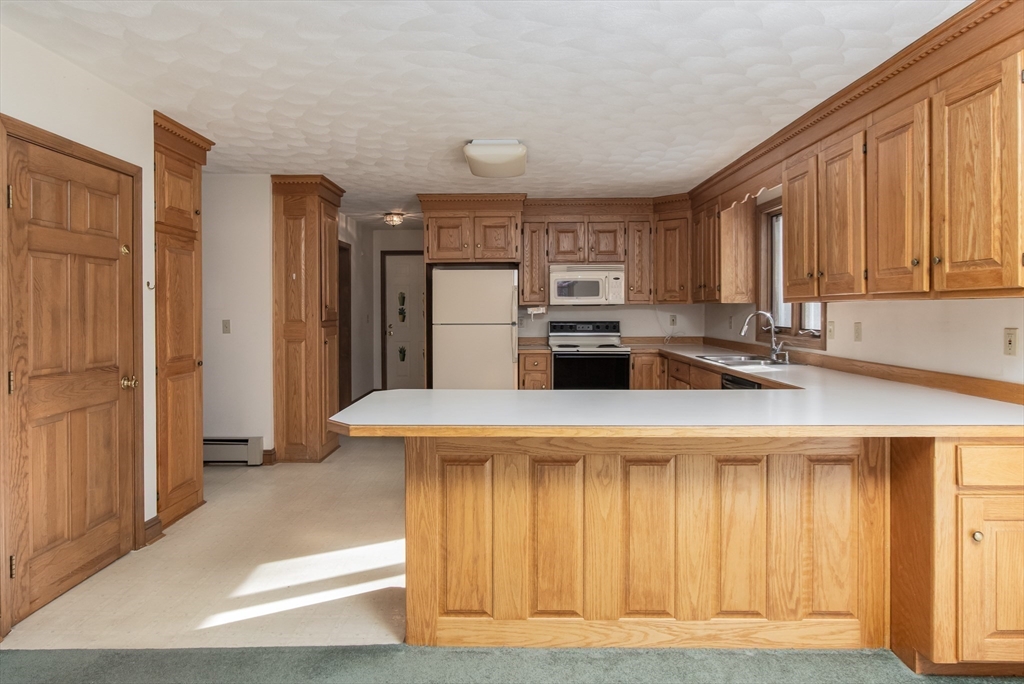 10 Ryan Road Townsend, MA 01474 - Photo 8 of 34 a kitchen with stainless steel appliances kitchen island a refrigerator sink and stove