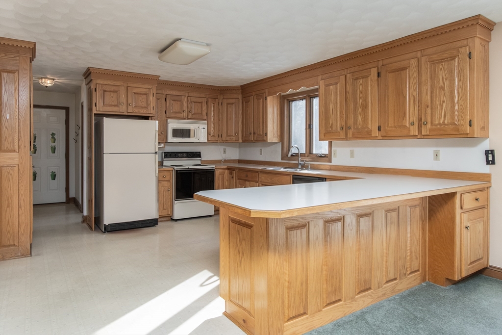 10 Ryan Road Townsend, MA 01474 - Photo 9 of 34 a kitchen with a stove a refrigerator and a sink