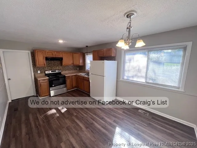 a kitchen with refrigerator and window