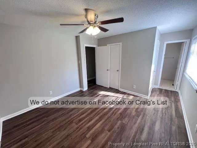 a view of a livingroom with wooden floor and a ceiling fan