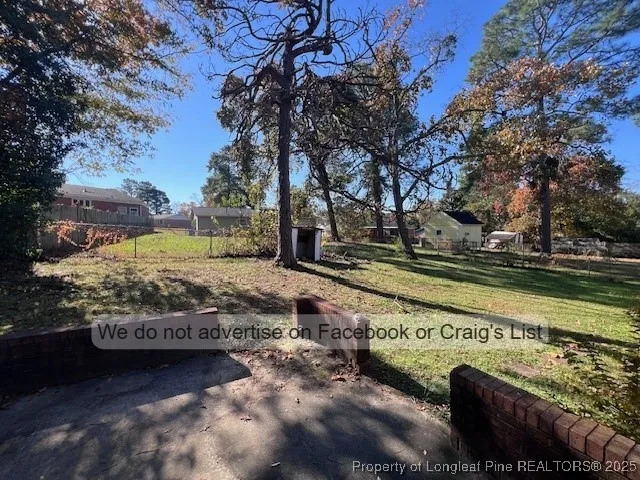 a view of a yard with large trees