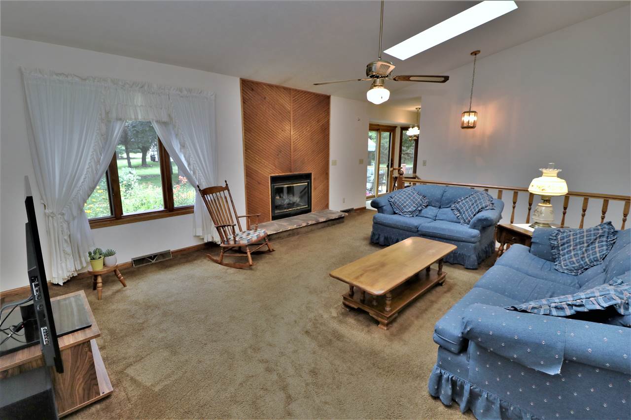 4158 Valerie Road Roscoe, IL 61073 - Photo 8 of 25 a living room with furniture and a fireplace
