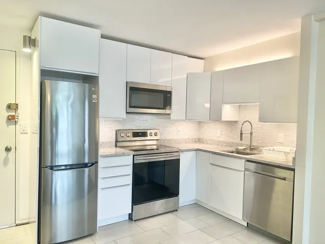 a kitchen with a sink stove and refrigerator