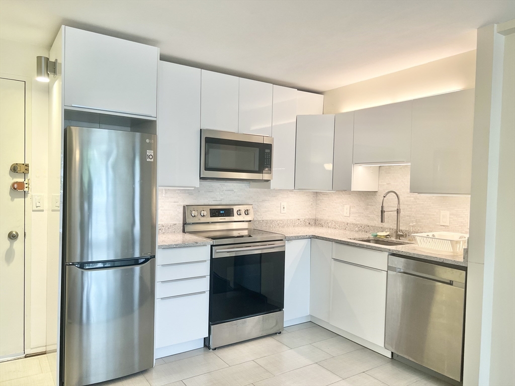29 Concord Avenue, Unit 405 Cambridge, MA 02138 - Photo 2 of 12 a kitchen with a sink stove and refrigerator