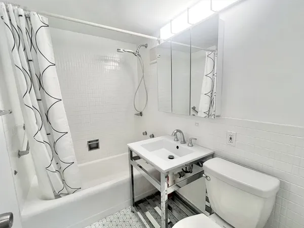 a bathroom with a sink a toilet and a bathtub