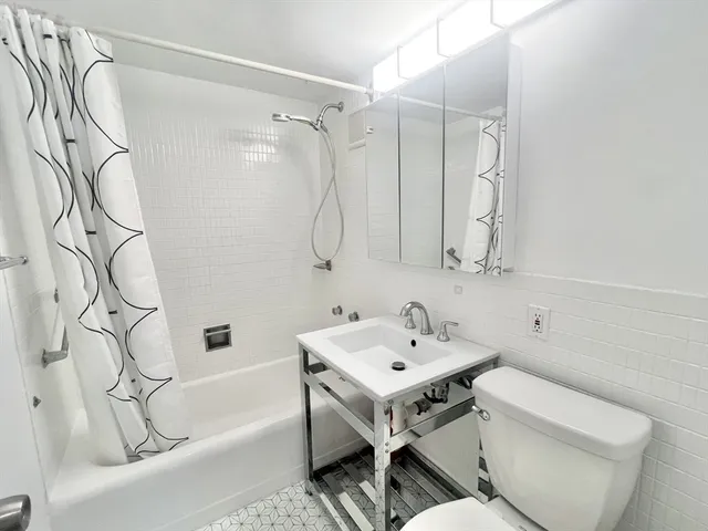 a bathroom with a sink a toilet and a bathtub