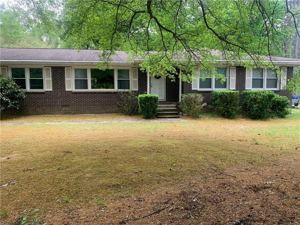 3519 Union Church Road Stockbridge, GA 30281 - Photo 1 of 1 a view of a house with floor to ceiling windows and a large tree