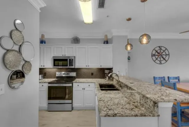 a kitchen with a stove a sink and a refrigerator
