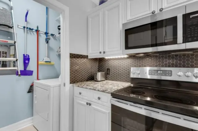 a kitchen with stainless steel appliances granite countertop a stove and a microwave