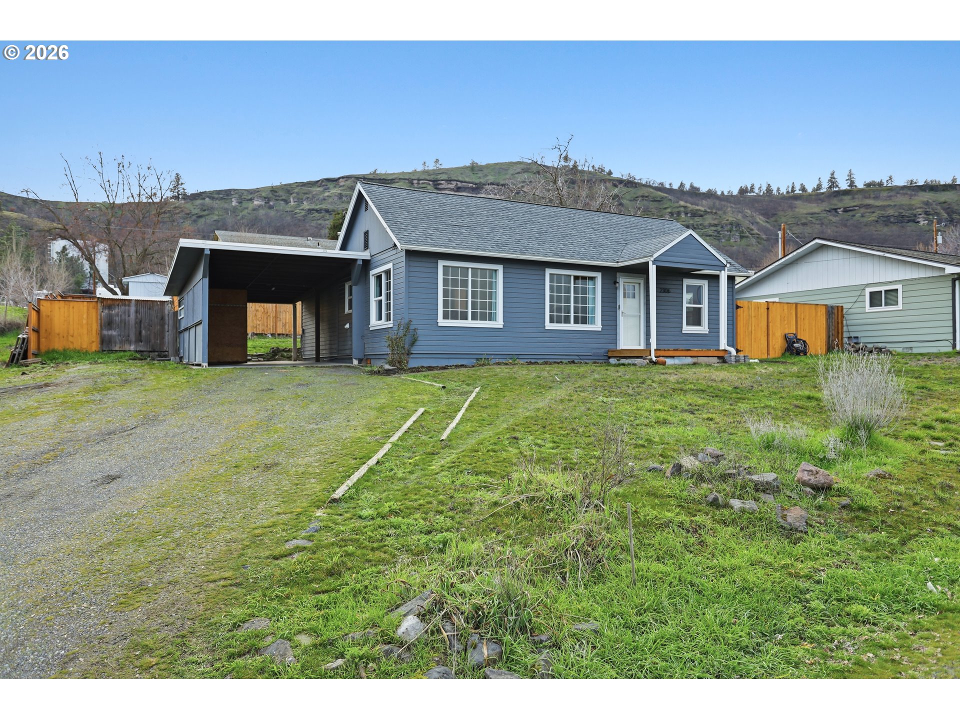 2306 West 13th Street The Dalles, OR 97058 - Photo 1 of 32 a view of a big house with a big yard and large trees