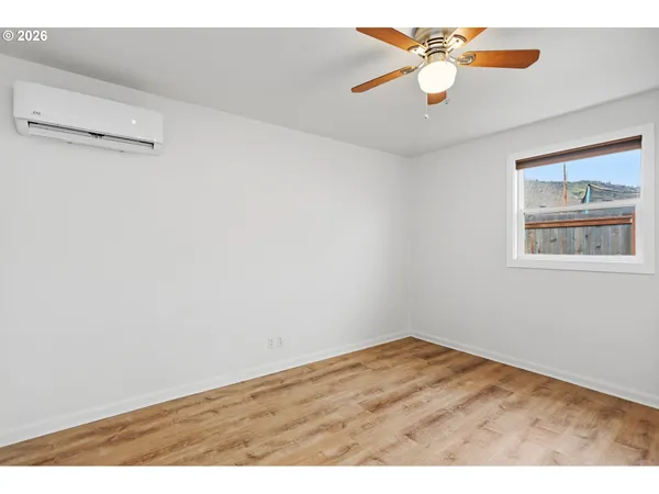 a view of an empty room with a fan