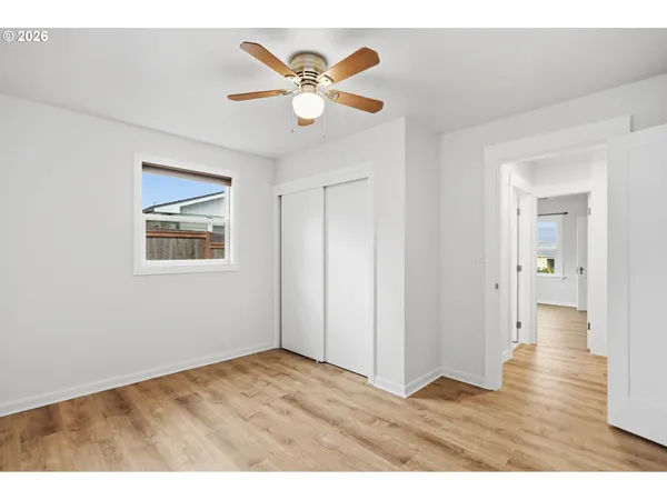 a view of an empty room with wooden floor