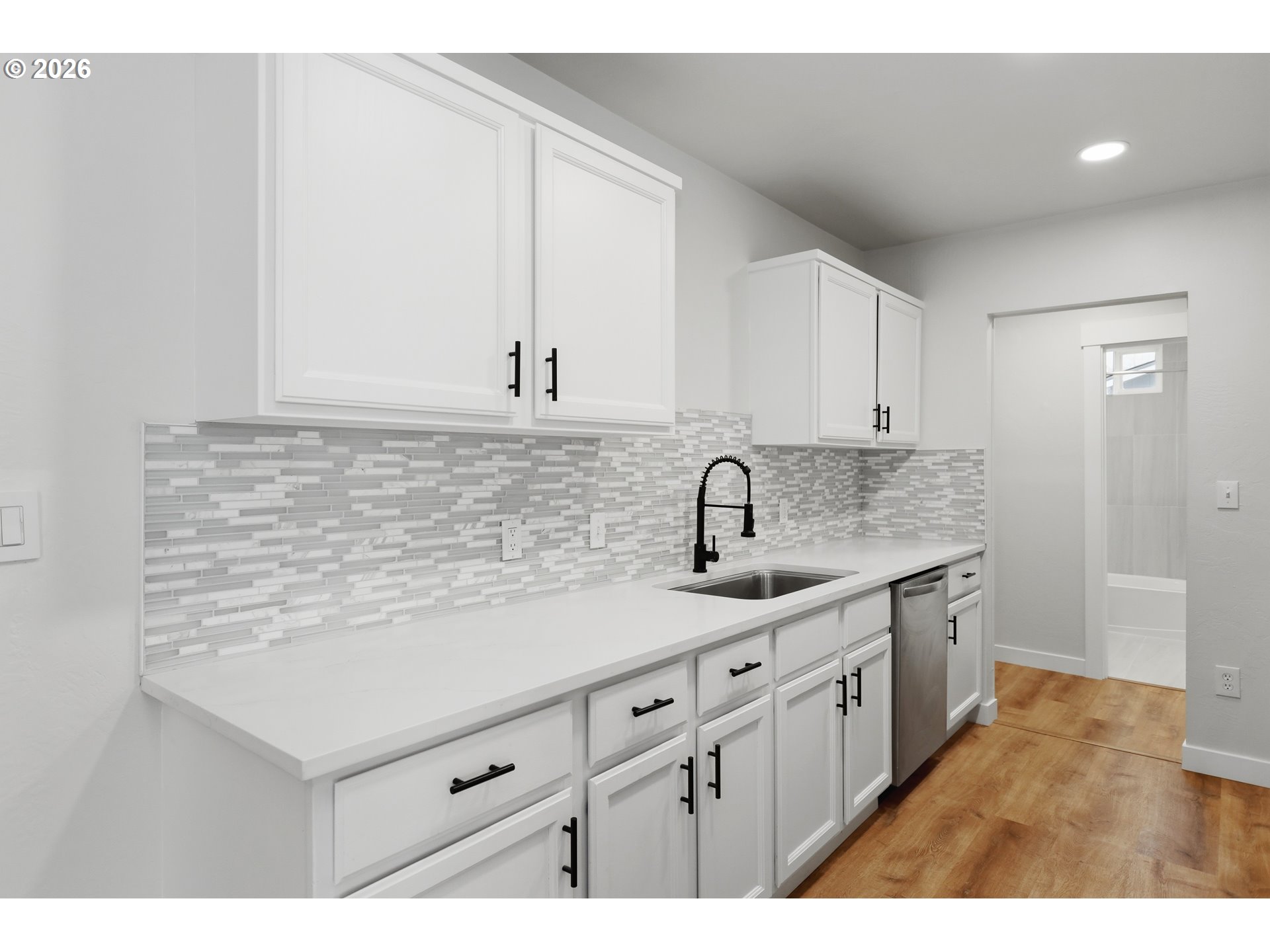 2306 West 13th Street The Dalles, OR 97058 - Photo 9 of 32 a kitchen with a sink dishwasher and cabinets