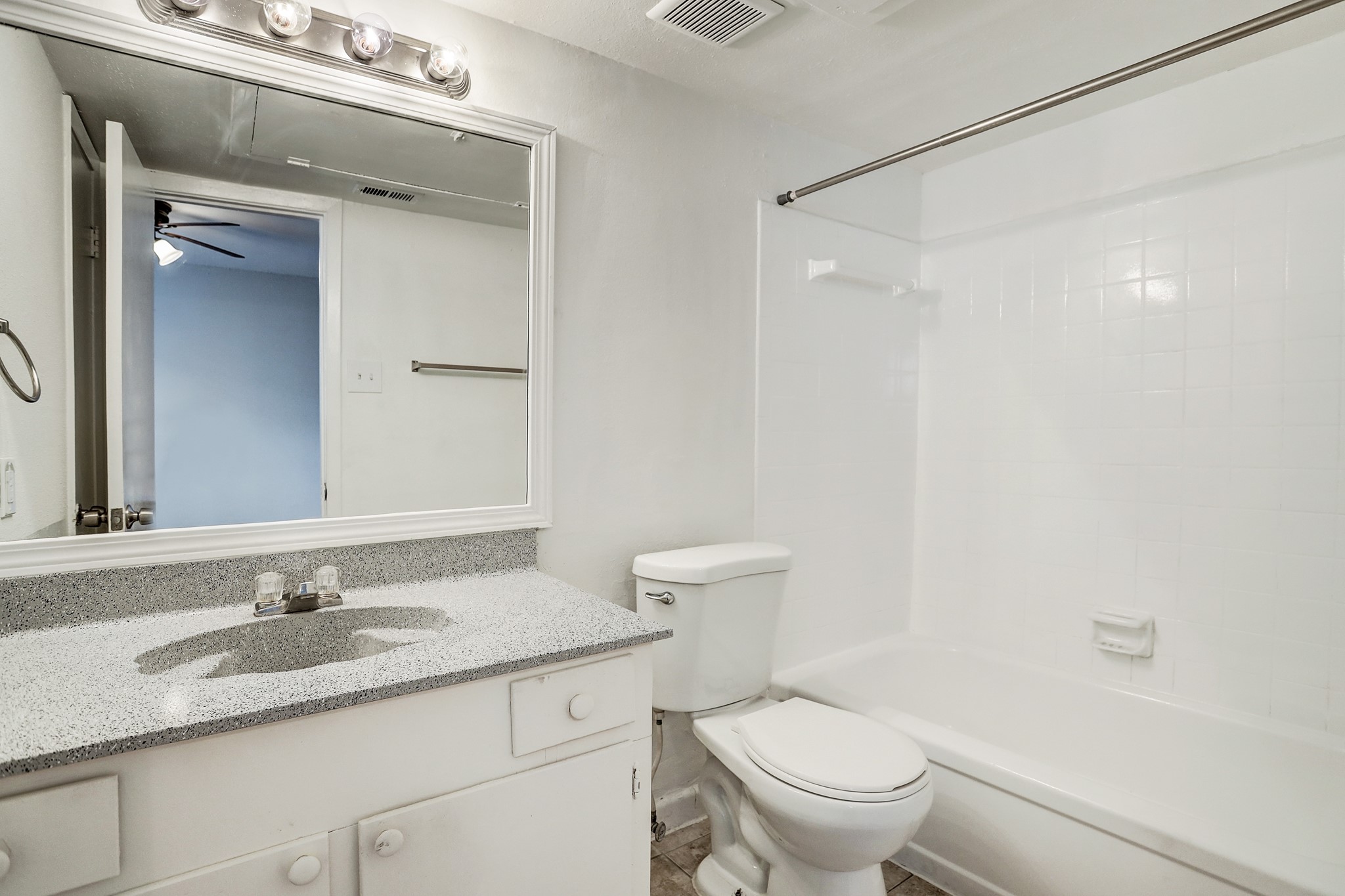 513 Ridge Street, Unit 21 Houston, TX 77009 - Photo 7 of 9 a bathroom with a granite countertop sink toilet and a mirror