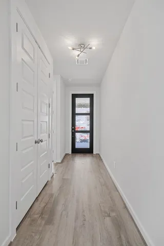 wooden floor in an empty room with a window