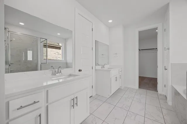 a spacious bathroom with a mirror sink and shower