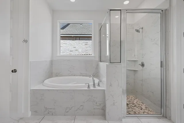 a bathroom with a bathtub and shower
