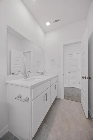 a spacious bathroom with a double vanity sink mirror and