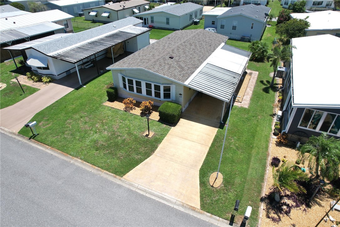 809 Oleander Circle Barefoot Bay, FL 32976 - Photo 1 of 29 an aerial view of a house with a garden and trees